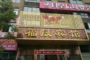 Un edificio con un letrero destacado que dice '福晖客馆' (Fukli Guesthouse).