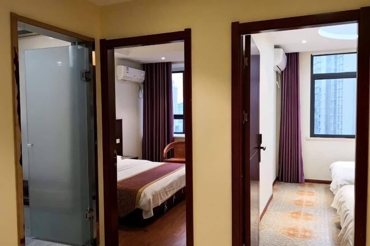 Een hotelkamer met een bed, een stoel, een raam en een deur.