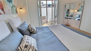 A bedroom with a bed, pillows, a large window, and a view of the outside. - The Perros house - PERROS GUIREC (PERROS GUIREC)