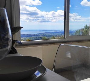 Enjoy a panoramic view of the coastal landscape from this room's large window.
