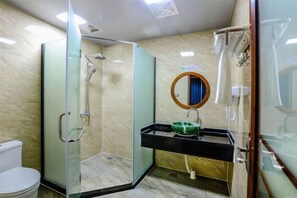 A bathroom with a glass-enclosed shower, a toilet, and a sink with a green basin. - Shanhai Coffee Inn (Zhangjiajie)