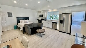 A modern, open-plan living space with a bed, kitchenette, and seating area. - ENTIRE MODERN LUXURY STUDIO PRIVATE FOR UP TWO PEOPLE AT WEST HIILS  (Los Angeles)