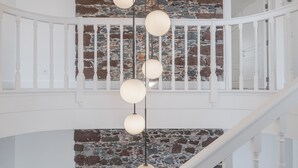 A staircase with a white railing and a stone wall. - Luxury, art and elegance - FAA Belas Artes 2 (Funchal)