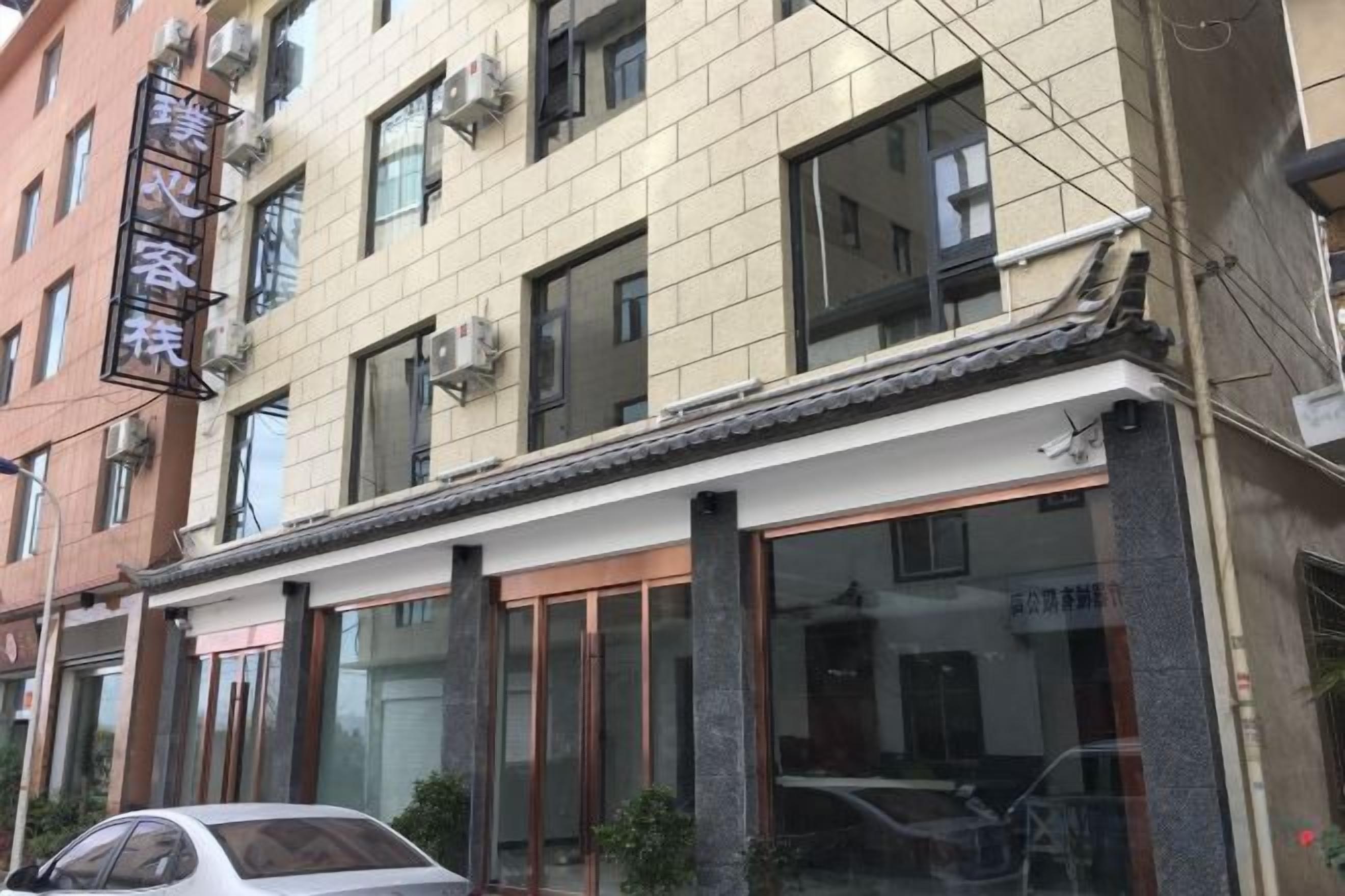 A building with a traditional architectural style, featuring large windows and a tiled roof.