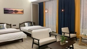 A hotel room with two beds, a chair, a small table, and a painting on the wall. - Puxin Inn (Dali City)