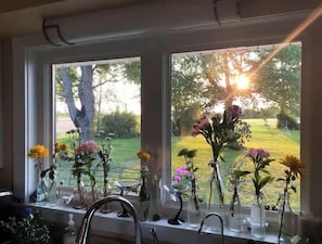 Enjoy a serene view of the lush garden through the windows, surrounded by beautiful floral arrangements.