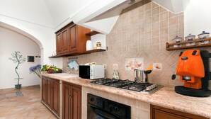 A kitchen with a stove, oven, microwave, and coffee maker. - Casa Sofia 310 steps (Positano)