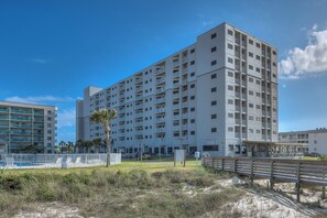 A multi-story hotel with balconies, a pool area, and a beachside location. - Gulf Shores Plantation-Dunes 5212 (Gulf Shores)