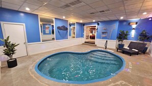 An indoor swimming pool with blue walls and a ceiling with recessed lighting. - Inn of The Dove Harrisburg-Hershey Romantic Suites (Harrisburg)