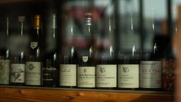 A row of wine bottles with labels, some featuring the year 2018.