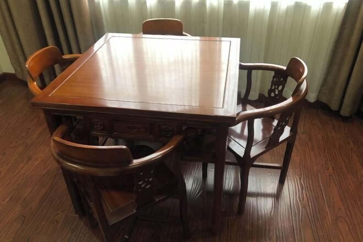A rectangular wooden dining table with six chairs.