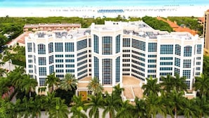A multi-story hotel with a modern architectural design, featuring large windows and a flat roof.