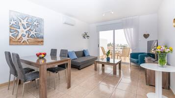 Superior Apartment, Pool View | Living area | 43-inch TV with satellite channels