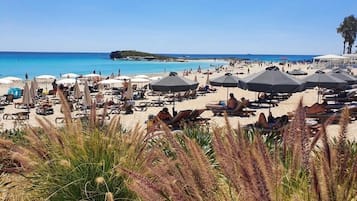 Beach nearby, white sand, sun loungers, beach umbrellas