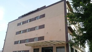 A multi-story building with a flat roof, a covered entrance, and a sign reading "The Skavatti Residency". - The Sravasti Residency (Ikauna)