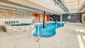 An indoor swimming pool with stone walls and a 'No Diving Allowed' sign.