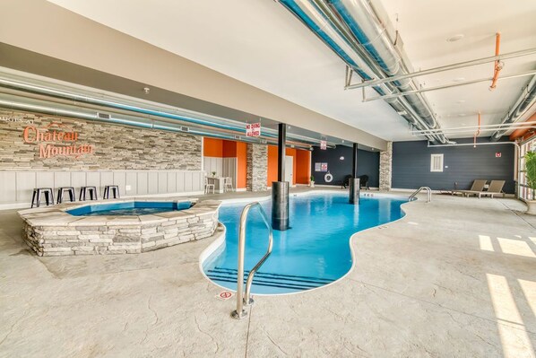 An indoor swimming pool with stone walls and a 'No Diving Allowed' sign.