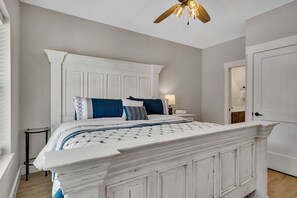 A bedroom with a white bed, a white headboard, and a ceiling fan. - Near Silver Dollar City with Private Hot Tub, Game Area, Community Indoor Pool & Free Daily Tickets (Branson)