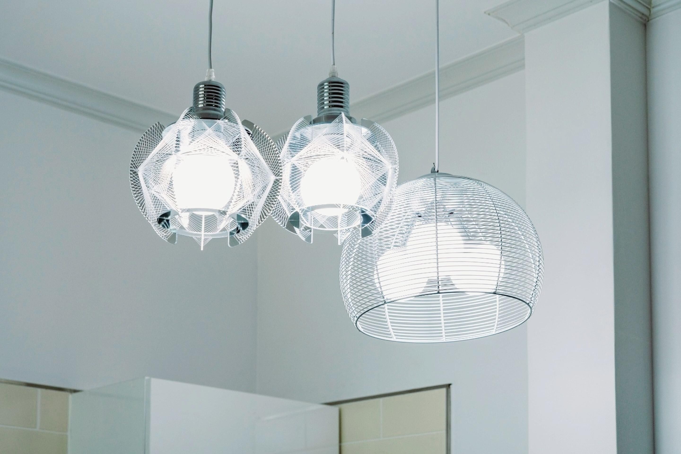 A modern bathroom with two hanging pendant lights and a large mirror.
