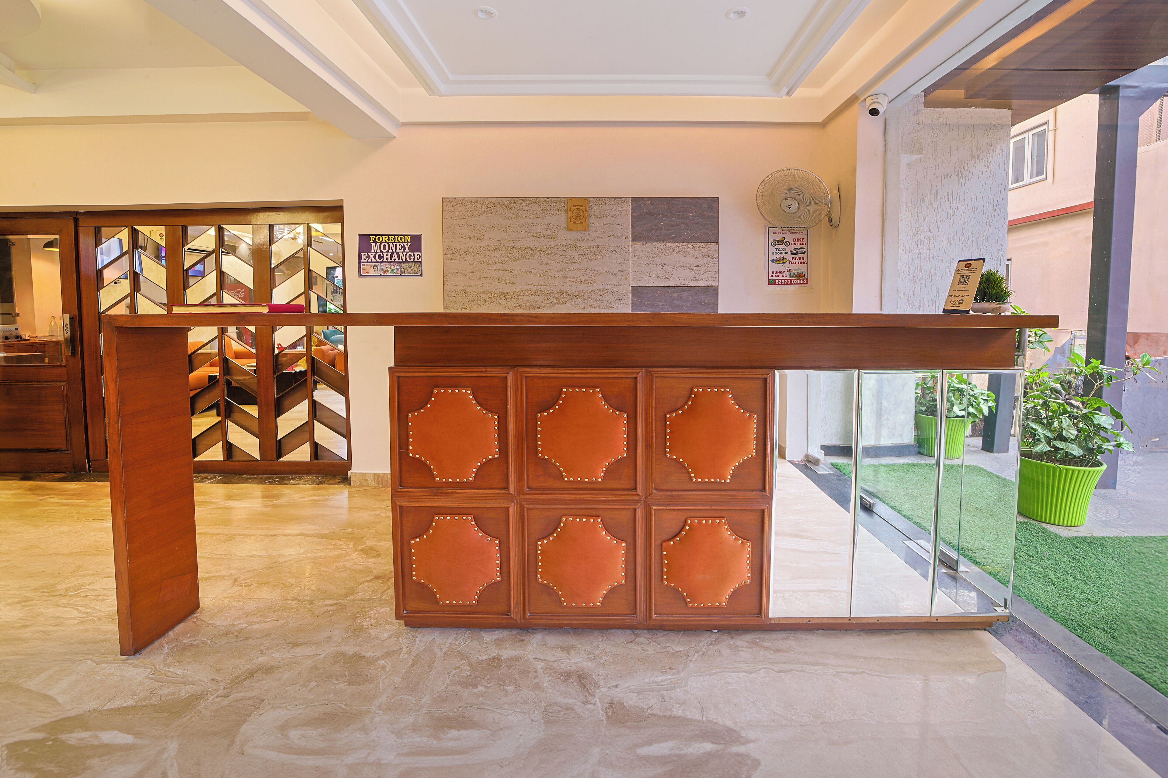 A reception desk with a tiled floor and a glass partition.