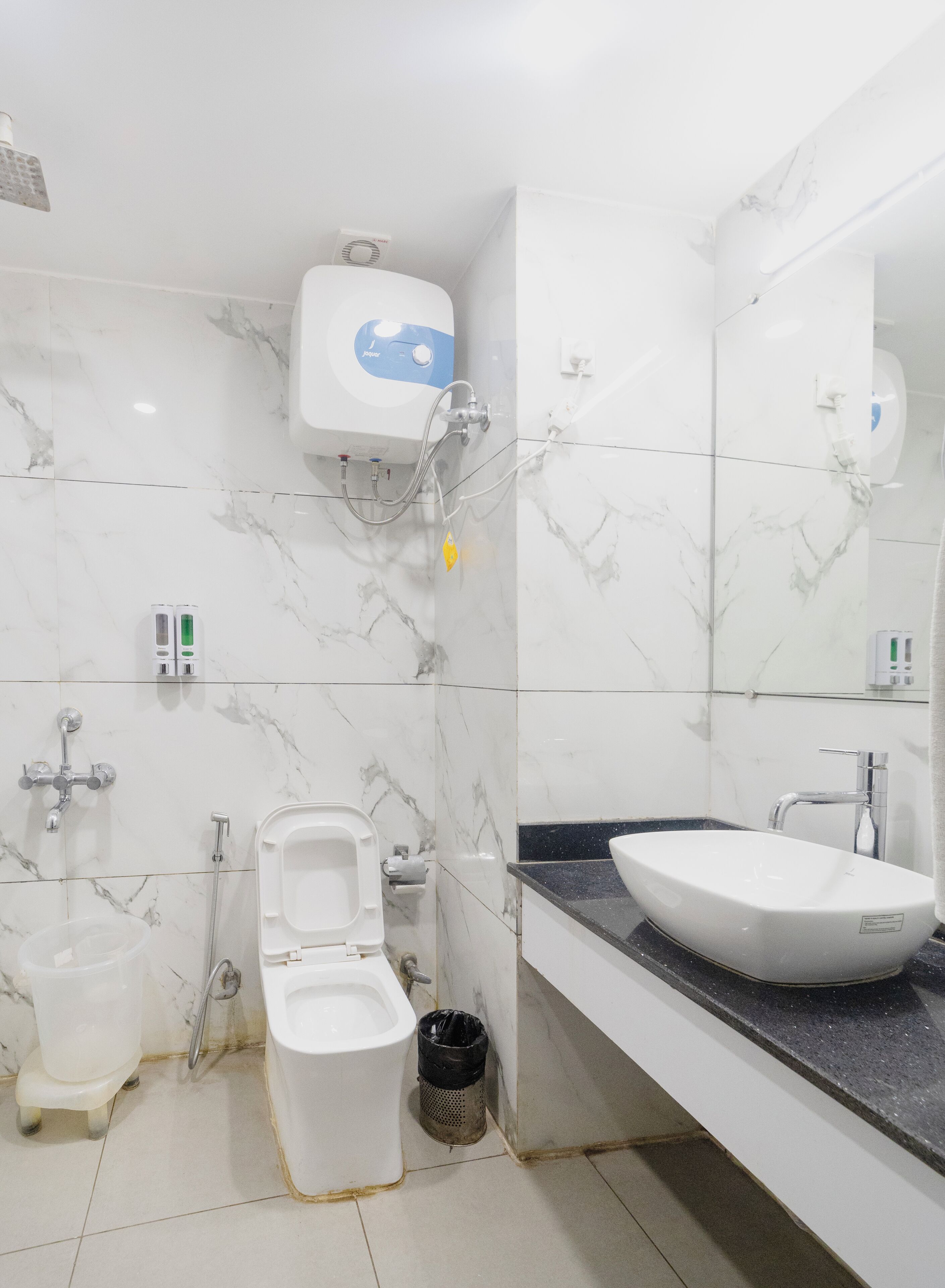A modern bathroom with a toilet, bidet, and sink.