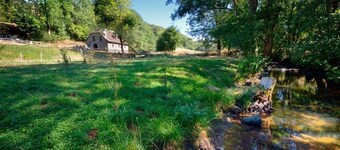 Isolated mill on river bank