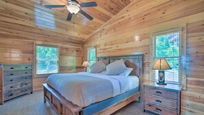 A wooden cabin bedroom with a bed, nightstands, and a ceiling fan. - ‘Hiwassee Hideaway' Cabin w/ Mountain Views! (Murphy)