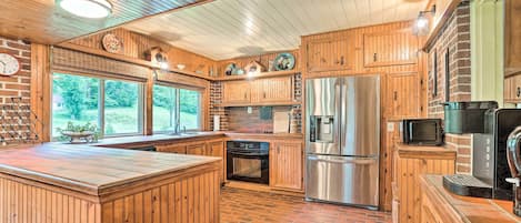 Enjoy cooking in this well-equipped kitchen with a sink, refrigerator, and microwave.