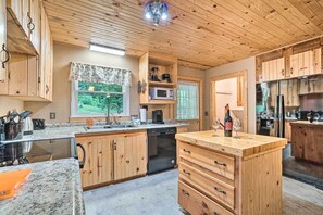 Kitchen features a clean design with cabinetry, a sink, and ample counter space for food preparation.