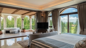 A spacious bedroom with a large bed, a flat-screen TV, and a balcony with a hot tub. - Toscana Valley Castello Della Valle (Pak Chong)