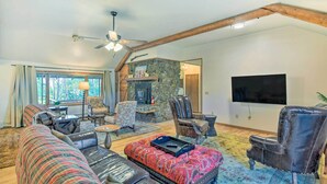 A spacious living room with a stone fireplace, leather sofas, and a flat-screen TV. - 'Moose Park Lodge' Charming Walden Retreat! (Walden)