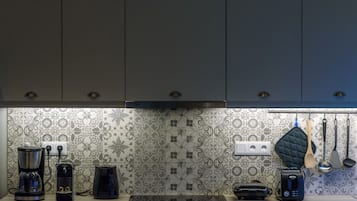 A kitchen with a coffee maker, toaster, and electric kettle on the counter.
