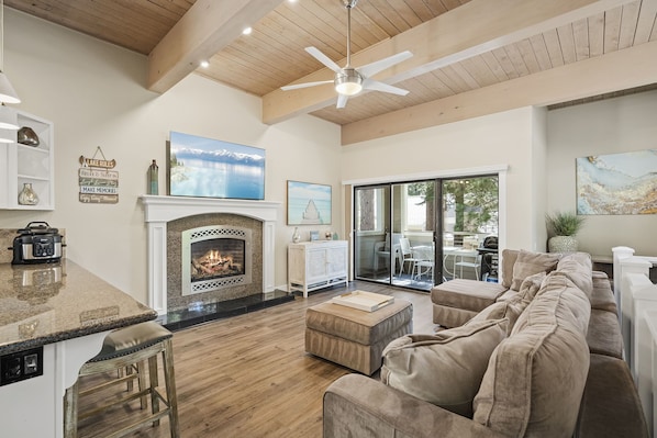 Relax in this inviting living area with a fireplace, large artwork, and comfortable seating.