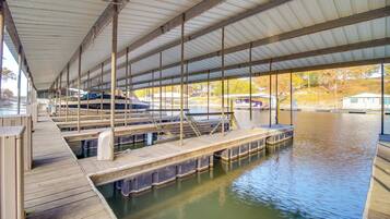 A covered dock area with boats and a calm water body.