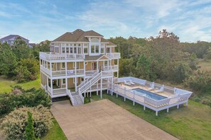 A multi-story house with a large deck and a swimming pool. - Semi-Soundfront Dog Friendly w/ Pool, Hot Tub, Elevator, Community Boat Ramp (Salvo)