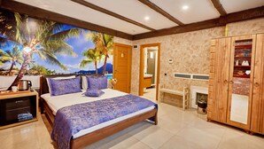 A bedroom with a bed, wooden wardrobe, and a mural of palm trees. - Ardey Hotel (Istanbul)