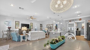 A spacious living room with a dining area, a kitchen, and a bedroom. - Updated Kitchen & Large Pool– Seacrest Simplicity Meets Coastal Comfort (Inlet Beach)