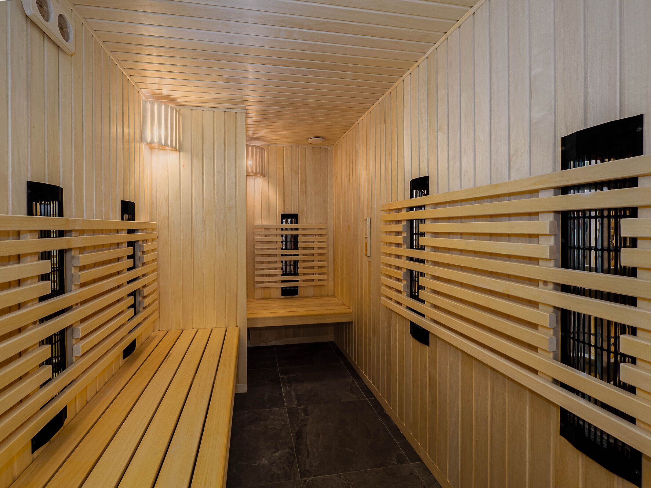 A sauna with wooden benches and slatted walls.