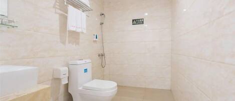 A bathroom with a toilet, a sink, and a shower.