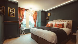 A bedroom with a large bed, a window with curtains, a dresser, and a chandelier. - Luxury Boutique 2 Bed Apartment in the heart of Bowness on Windermere (Bowness-on-Windermere)