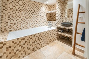 Bathtub, hair dryer, towels, soap