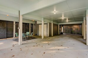 Open-plan space with columns, seating areas, and a light-colored floor.