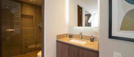 A modern bathroom with a glass shower enclosure, a double sink vanity, and a large mirror.