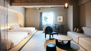 A hotel room with two beds, a sofa, a dining table, and a chair. - Korinkyo (Kanazawa)