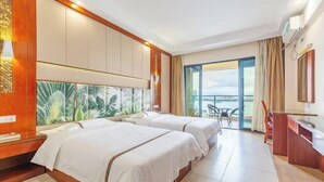 A hotel room with two beds, a large window, a balcony, and a desk with a chair. - Xingyu Sea View Hotel (Sanya Nanbian, Hailu Huitou) (Sanya)