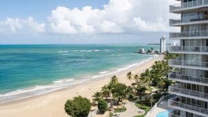 A beachfront hotel with a pool, beach, and ocean view.