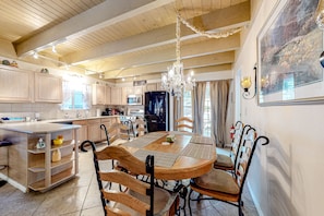 Enjoy meals in the kitchen with a central island, sink, and storage, and dine at the wooden table with matching chairs.