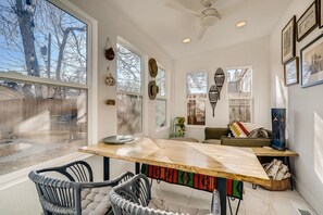 A modern interior with a dining area, a sofa, and a fireplace.