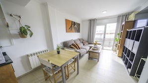 Una sala moderna con una mesa de comedor, sofá y estanterías empotradas.