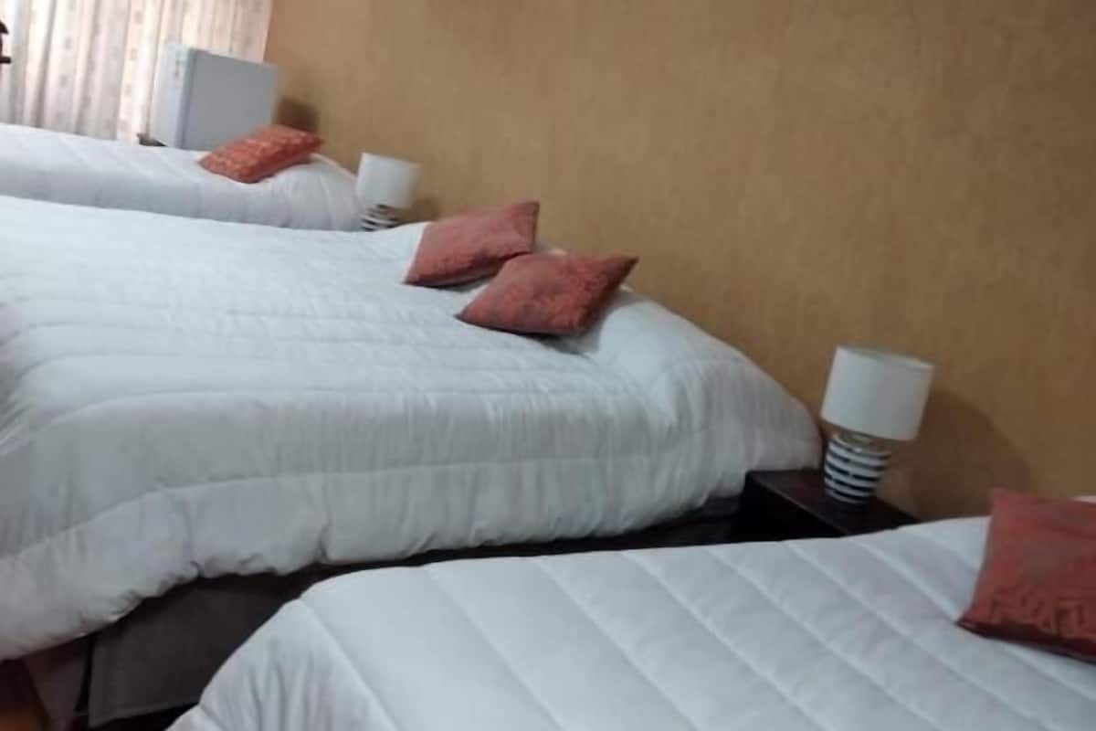 deluxe quadruple room | premium bedding, desk, laptop workspace, iron/ironing board